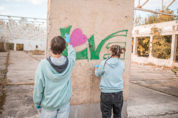 istock Back view of two street artists drawing graffiti 2007595331