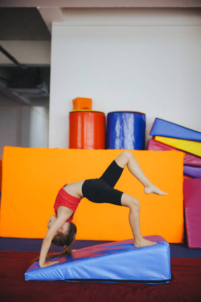 Cute active child girl in sensory integration room, kindergarten. Kid is active leisure. Childhood and sporty lifestyle.Sports weekend in gymnastic center. Fitness,healthy, develop skills concept