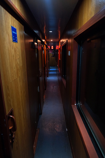 Empty hallway in old sleeping wagon of train at night.