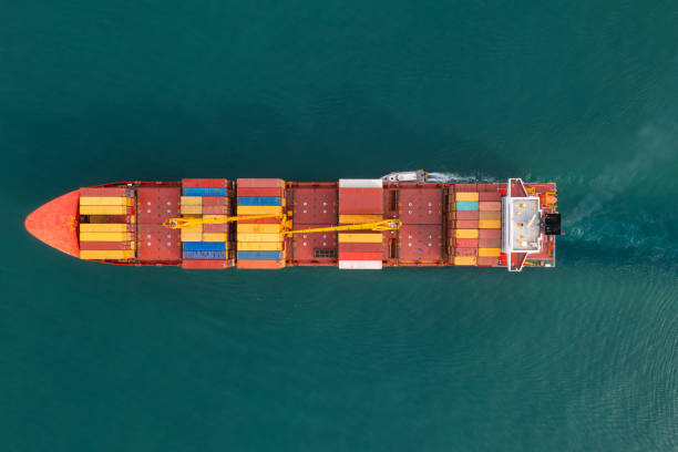 istock Aerial view of cargo container ship carrying containers for import and export, business logistic and transportation in open sea. Top down drone view 2007602460