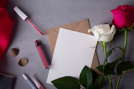 Creative desk setup with vibrant flowers and chic stationery for inspired correspondence.