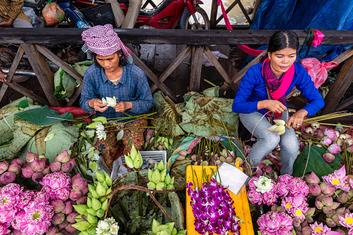 Cambodian women selling flowers on a local market in Siem Reap, Cambodia