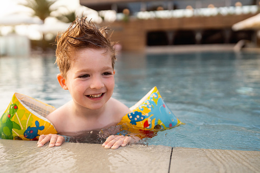Little boy enjoying a day at the swimming pool.