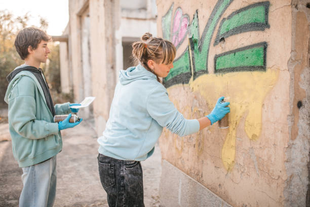 istock Side view of two focused street artists drawing graffiti 2007628369