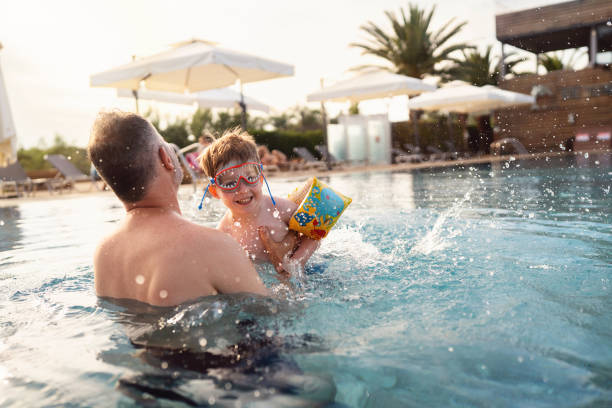 istock Father and son enjoying a day at the swimming pool 2007628899