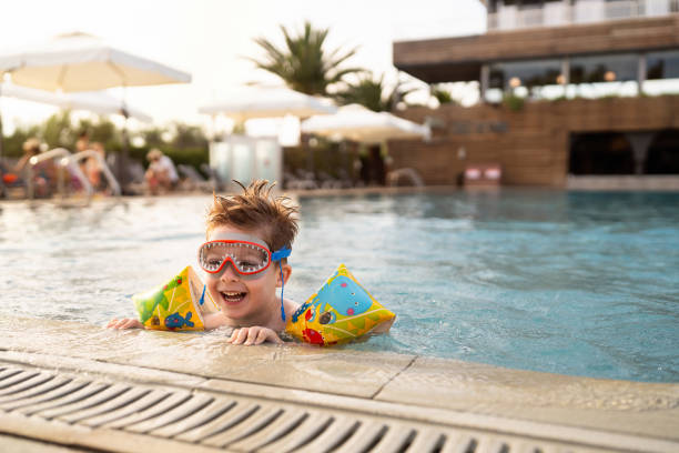 istock Little boy enjoying a day at the swimming pool 2007629459