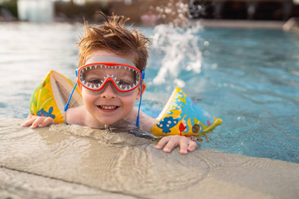 istock Little boy enjoying a day at the swimming pool 2007631028