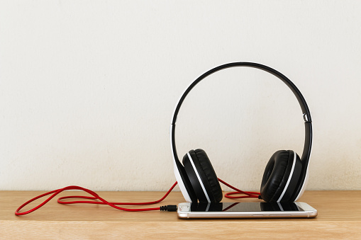 Headphones  and smartphone on wood floor background ,Concept listen to music