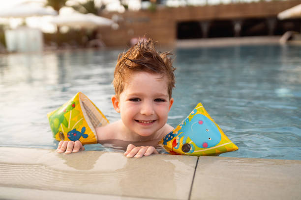 istock Little boy enjoying a day at the swimming pool 2007631608