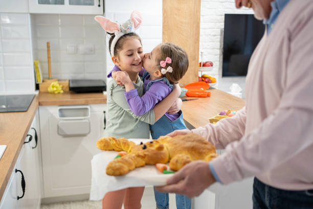 istock Caucasian sisters enjoying the Easter celebration with their grandfather 2007645865