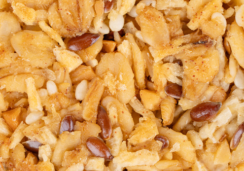 Granola cookies with healthy cereals and grains in honey close-up under the background