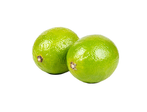 Two juicy fresh limes isolated on white background