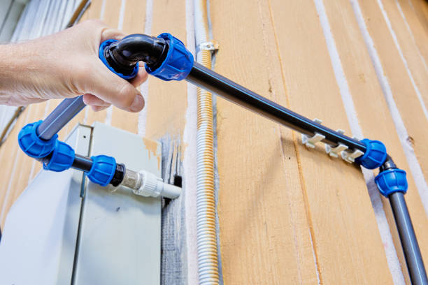 istock Installing an outdoor pipeline for drinking water and irrigation, plumber tightens elbow compression fitting nut. 2007654214
