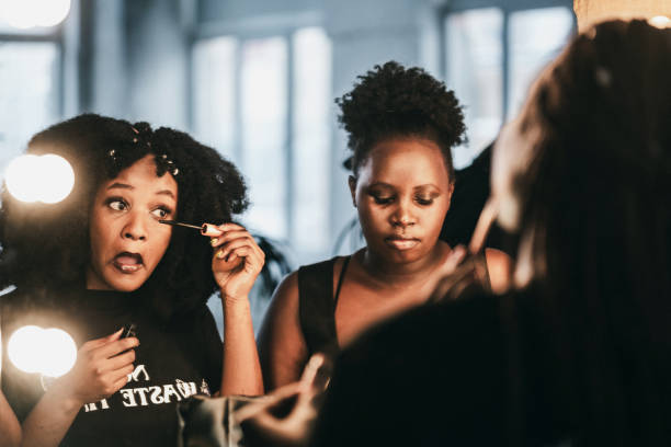 istock Black women doiang a make-up near mirror 2007666292