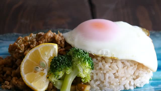 Close-up video of gapao rice. Thai food made with ground meat and spices.