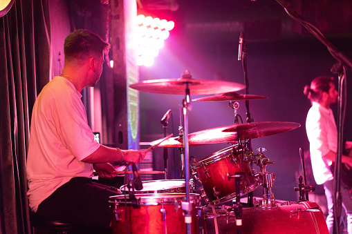 Musician plays drum on stage photo