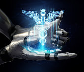 Blue caduceus hologram floating over robotic hand while other hand doing thumbs up gesture. Cyber medicine concept