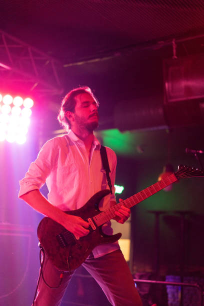 istock Musicians playing electric guitar on stage 2007683367