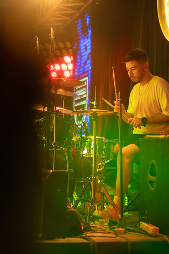 Musician plays drum on stage