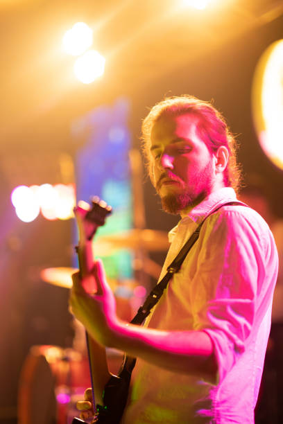 istock Musicians playing electric guitar on stage 2007689127