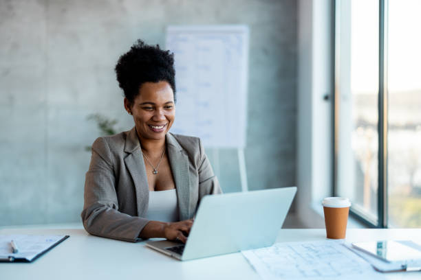 Young Black Female Working on Laptop Computer in Creative Office