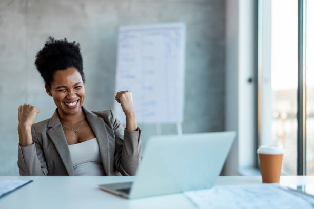 istock Young businesswoman cheering while using a laptop in an office at work 2007691737