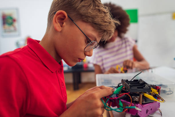 istock Children students building robotic cars at STEM classv 2007692253
