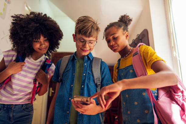 istock A group of elementary school students at the school lobby using smartphone 2007700161