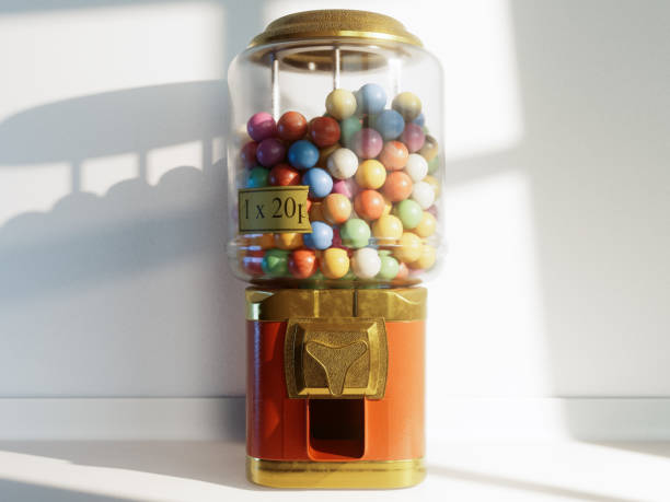 Pink gumball machine with a clear glass container full of colorful gumballs. The machine is on a black background.