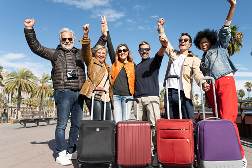 Group of tourists bonding celebrating friendship together after happy vacations trip