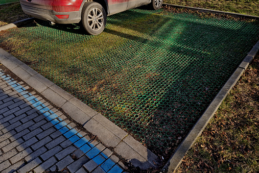 paved lawns with a share of gravel allow b in the city to park cars in the parking lot. sometimes they are reinforced with plastic grass tiles with locks that can withstand even heavier vehicle