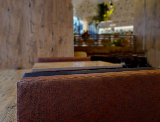 istock gray window frame high above the street. restaurant with brown leather sofas in dining room style. interior plants, trees create an atmosphere of airiness 2007740619