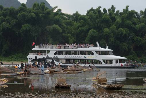 Yangshuo County, Guilin, Guangxi, China - July 29, 2023: A cruise ship of Guilin Tourism Co., Ltd. carries tourists on the Li River