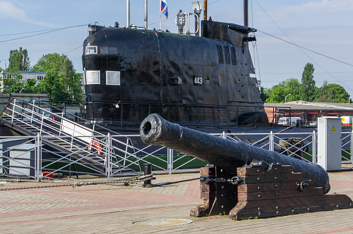 Soviet diesel-electric submarine B-413 is exhibited at pier of Museum of World Ocean. In foreground is an old ship's cannon. Object of cultural heritage of Russia. Kaliningrad, Russia, June 16, 2012