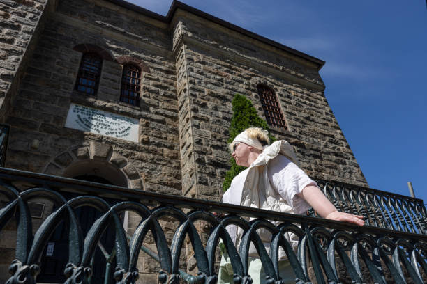 Historical site visit: woman exploring an old brick prison during her solo travelling in Jim Thorpe, PA. Low angle view