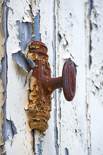 Antique, rusty door handle on an old wooden door in Bourgogne