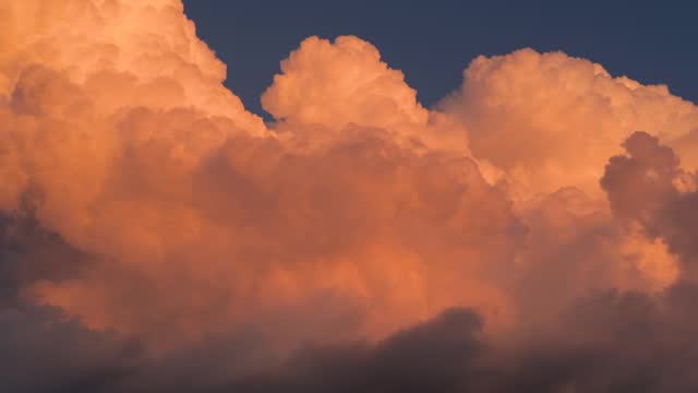 sunset orange clouds in bright blue sky, cloud movement speed up footage, amazing natural cloudy shape change