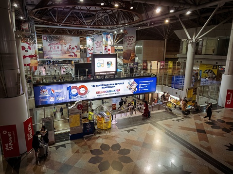 Kuala Lumpur, Malaysia – October 22, 2022: Commuters in KL Sentral transportation hub in Brickfields, KL. KL Sentral is Malaysia largest intermodal transportation hub.