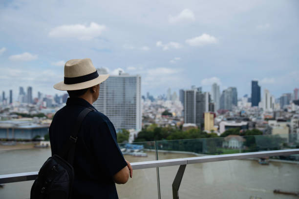 istock Happy senior man leaning on railing at building terrace 2007812659