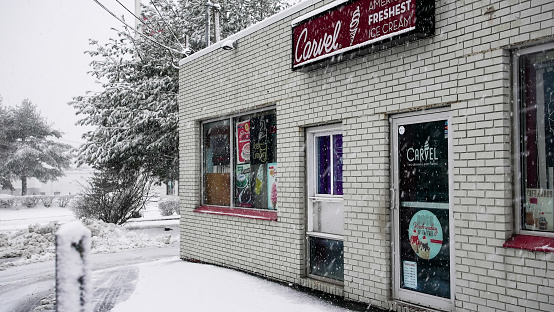 Norwalk, CT, USA - February 13, 2024:  Snowstorm in February 2024 on East Coast and Carvel ice  cream store front