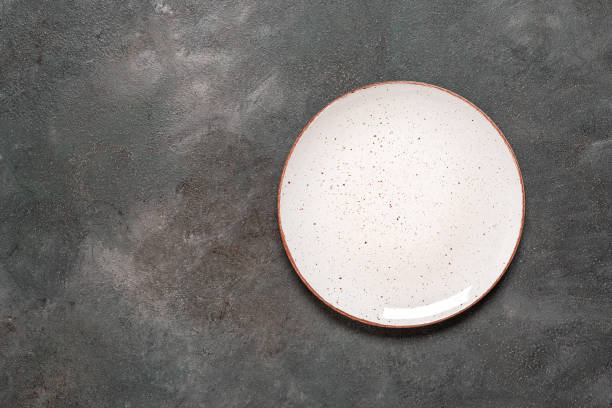 istock Empty white plate on a dark grunge background. Top view, flat lay, copy space. 2007830525