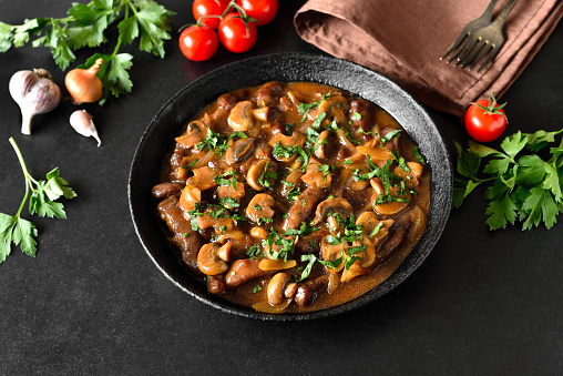 Tasty beef stroganoff with mushrooms in frying pan