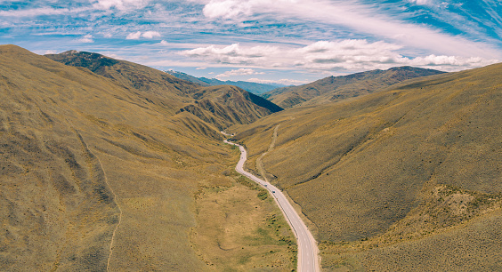 Experience the breathtaking aerial view of Lindis Pass in New Zealand. This stunning landscape showcases the natural beauty of New Zealand's South Island from above.