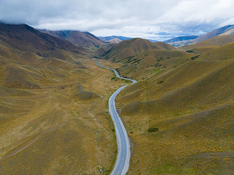 Experience the breathtaking aerial view of Lindis Pass in New Zealand. This stunning landscape showcases the natural beauty of New Zealand's South Island from above.