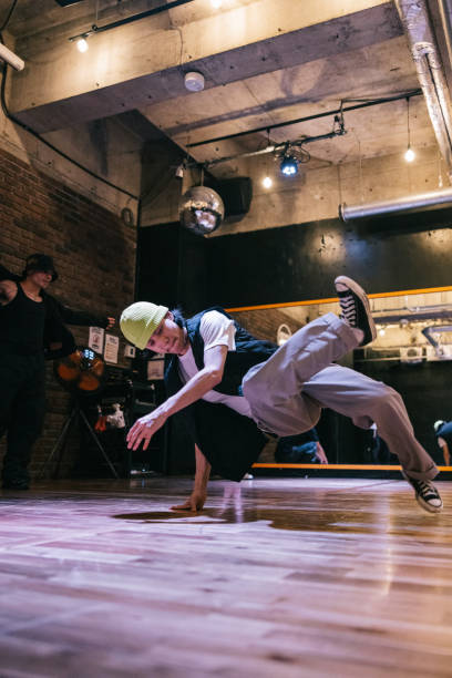 istock Young Japanese man doing breakdance moves in a dance studio 2007849638