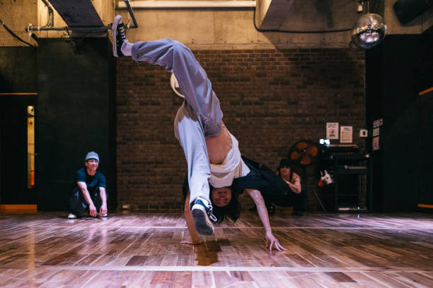 istock Hip Hop dancer doing a handstand while performing for friends 2007849639