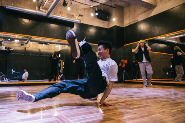 istock Young Japanese man doing breakdance moves in a dance studio 2007849641