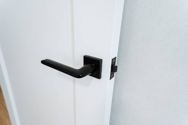 istock Black door handle on a white door. Isolated on a white background. 2007851300