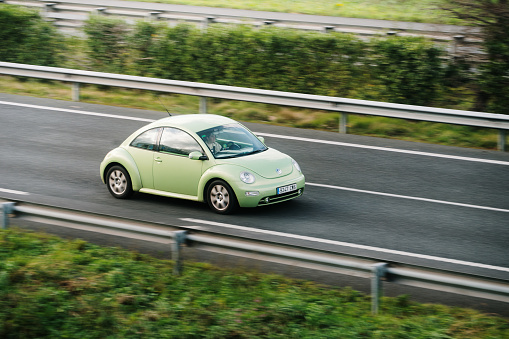 Santander, Spain - 12 February 2024: A Volkswagen New Beetle in motion on a highway