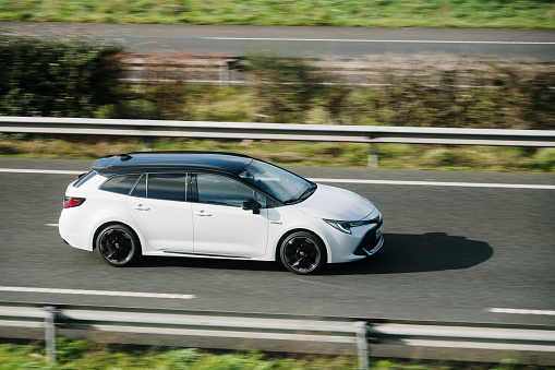 Santander, Spain - 12 February 2024: A Toyota Corolla Touring Sports in motion on a highway